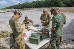 Florida National Guard Soldiers from the 54th Security Force Assistance Brigade prepare for a live-fire exercise to train multinational partners from Guyana, Antigua and Barbuda Merchant Marines at Camp Seweyo, Guyana, July 21, 2023.