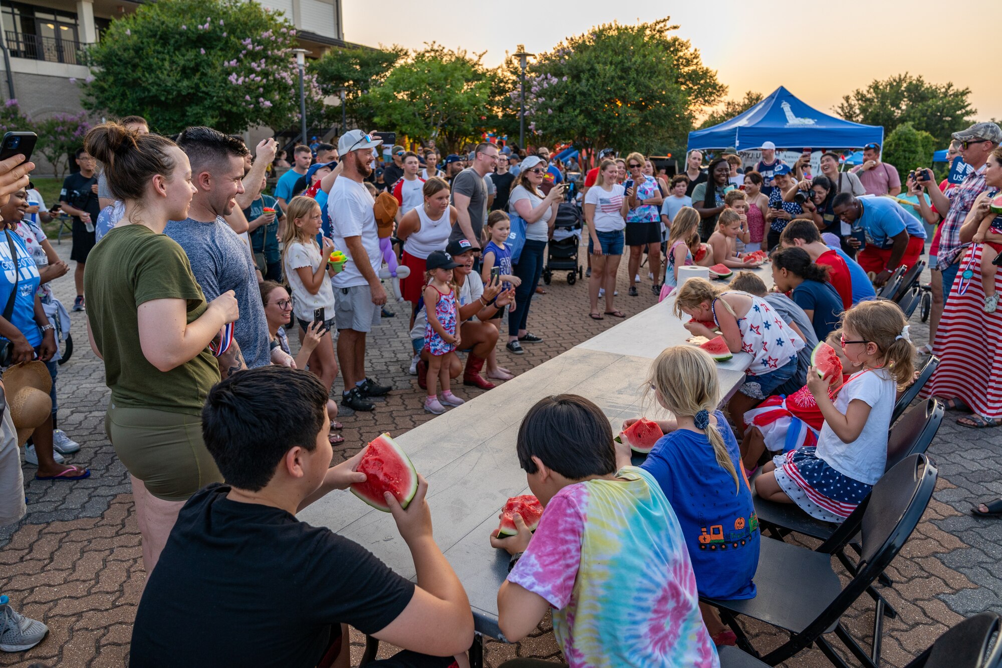 Airmen and their families gather for the watermelon eating competition during Freedom Fest 2023 at Keesler Air Force Base, Mississippi, June 30, 2023.
