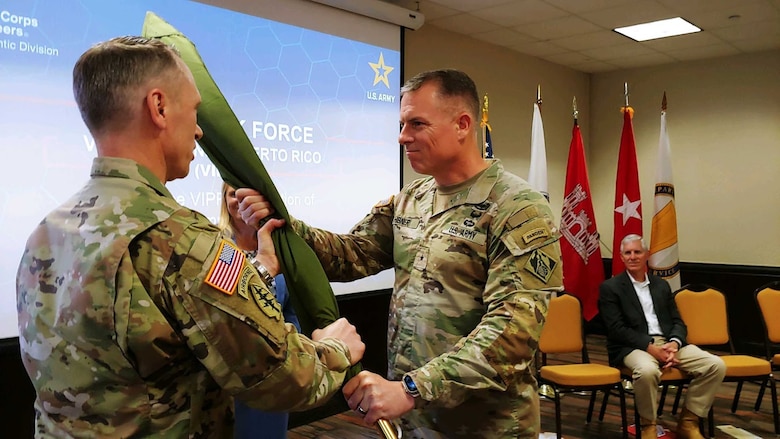 South Atlantic Division Commander Brig. Gen. Daniel Hibner presents a flag to Col. Charles Decker during an Army assumption of command ceremony.