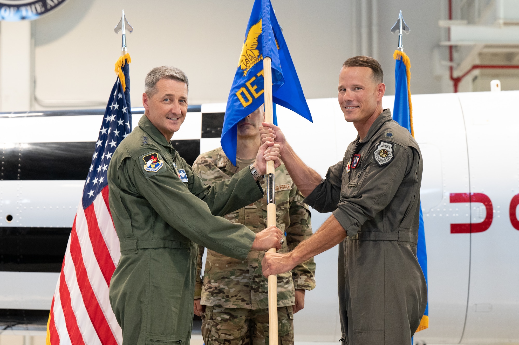 Lt. Col. Nick Pettit, commander, 1st Air Force, Detachment 3, accepts the Det. 3 guidon from Lt. Gen. Steven S. Nordhaus, commander, Continental U.S. NORAD Region - 1st Air Force (Air Forces Northern and Air Forces Space), during a Change of Command ceremony July 20, 2023, Patrick Space Force Base, Fla.