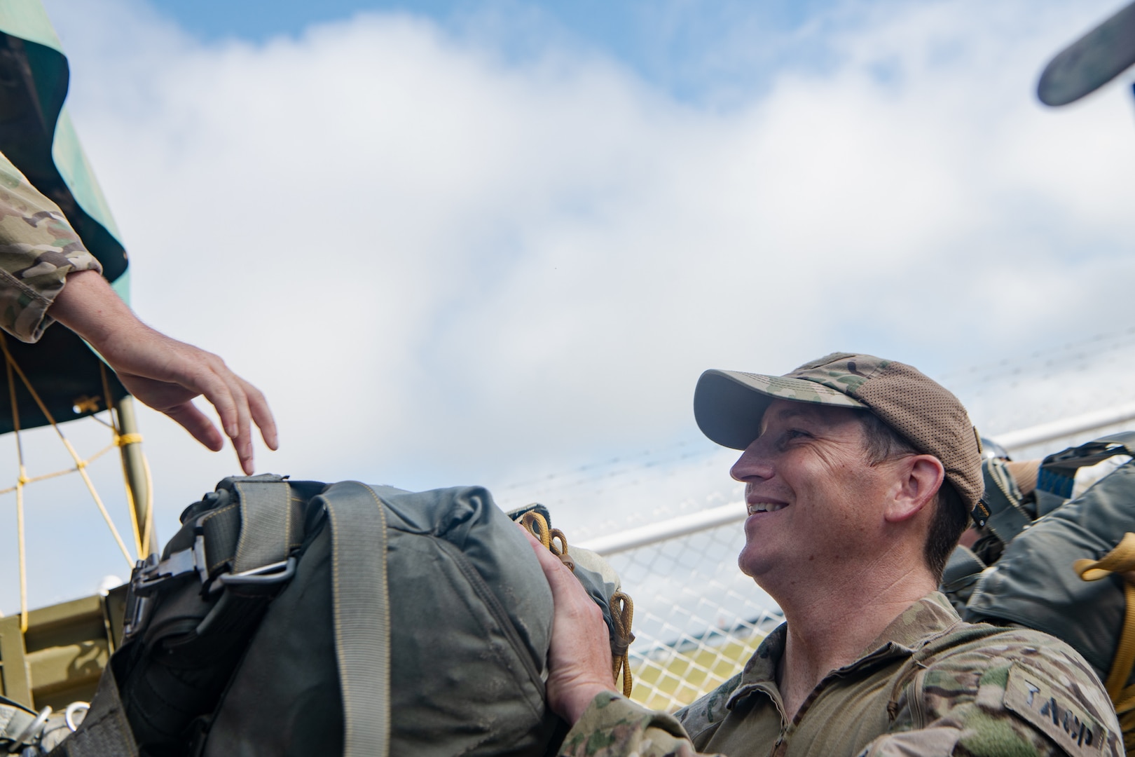 Photo: U.S. Air Force 1st Lt. Christopher Vaughan, 137th Special Operations Wing, Oklahoma National Guard, receives a static line parachute in preparation for a static line jump during TRADEWINDS23 Exercise over Air Base London, Guyana, July 18, 2023. The different training components of the exercise are focused on increasing regional cooperation throughout the Caribbean and Caribbean Basin. (U.S. Air National Guard photo by Tech. Sgt. Brigette Waltermire)