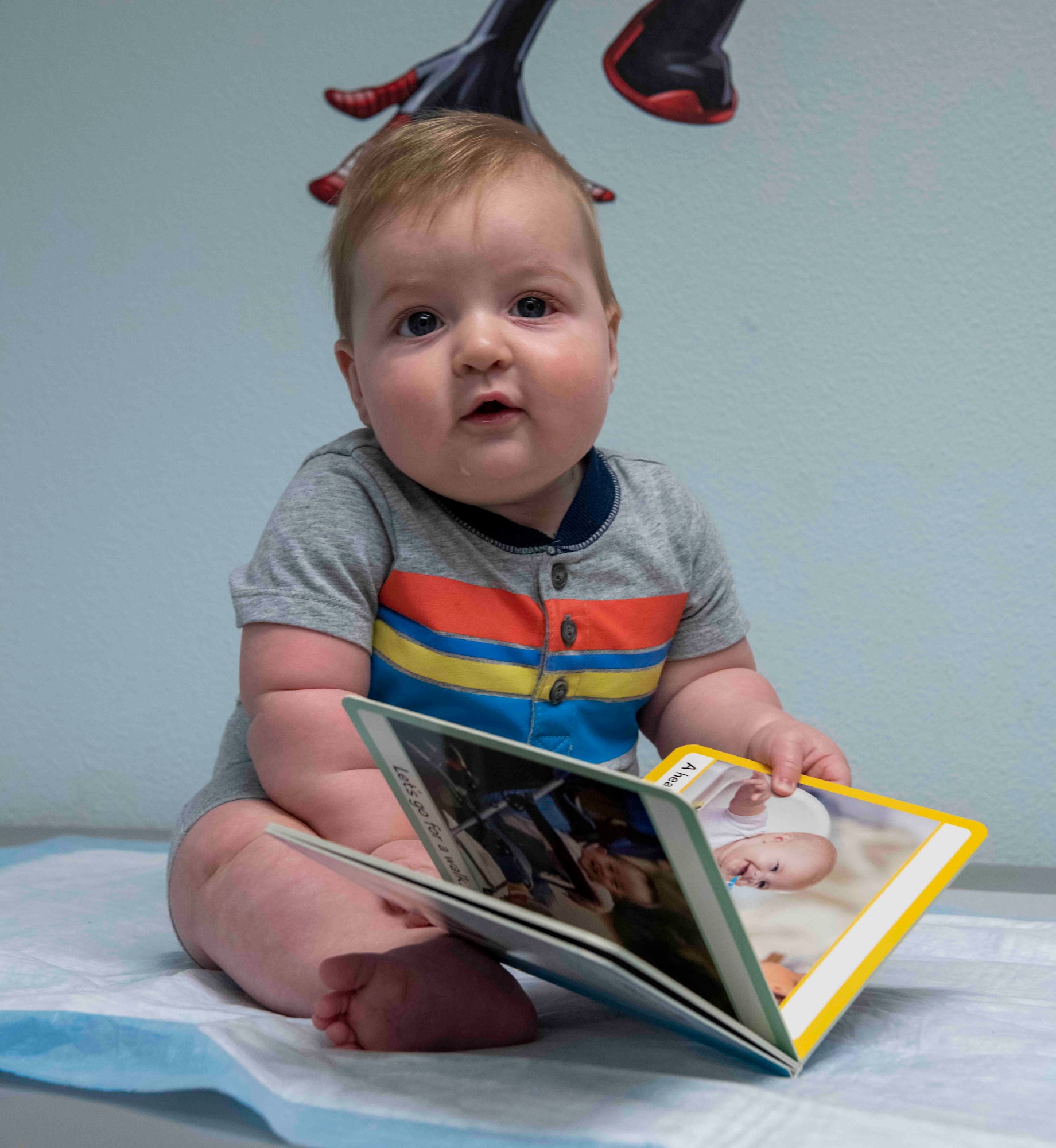 Oliver Carson is given a book as part of the Reach Out and Read Initiative during a clinical visit to the pediatrics clinic June 19, 2023, at Beale Air Force Base, California.