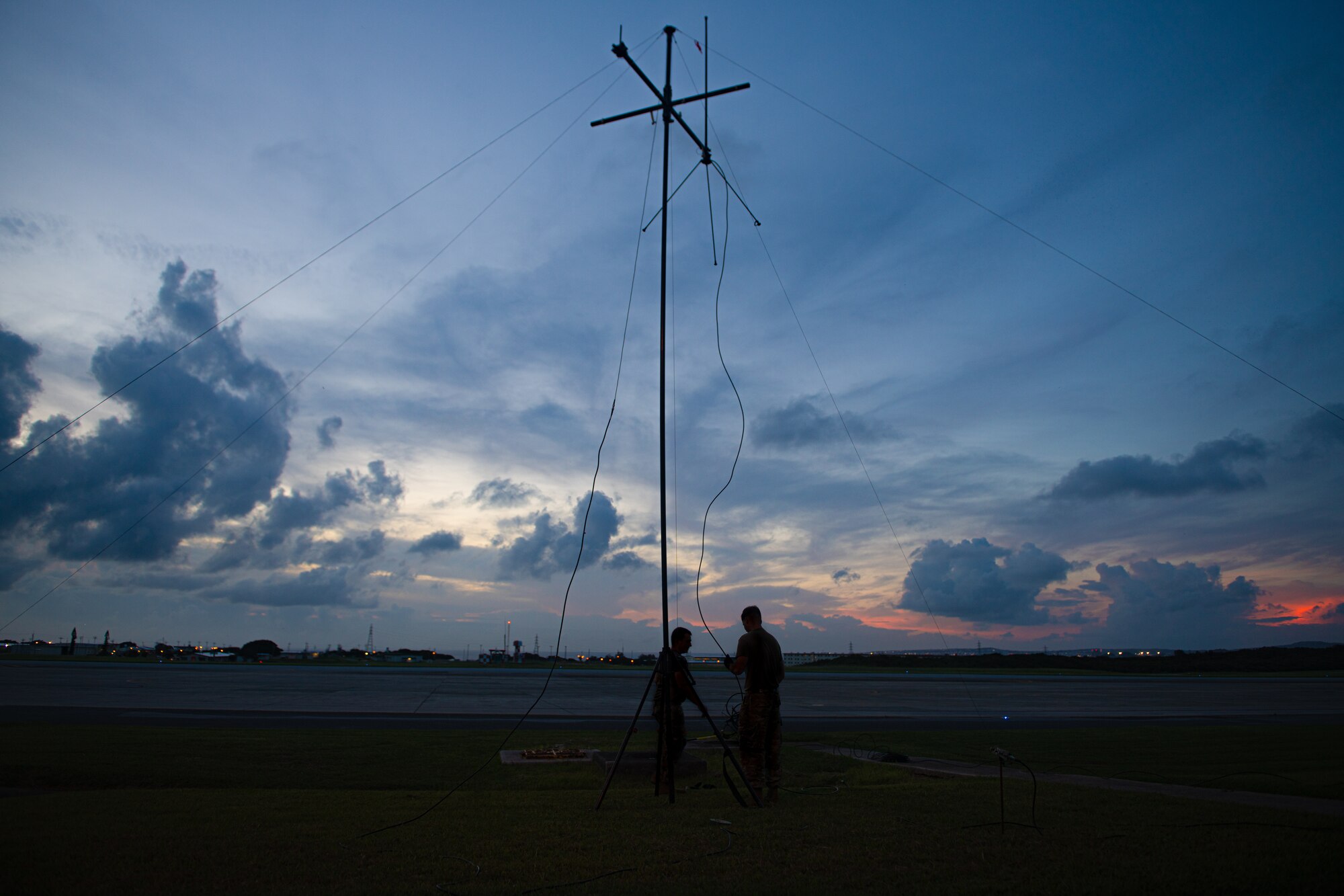 Airmen set up a radio antenna.