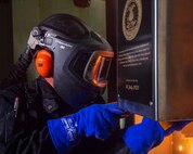 Newport News Shipbuilding contractor Wesley Smith, from Moyock, North Carolina, welds a time capsule following a mast stepping ceremony held onboard the Nimitz-class aircraft carrier USS John C. Stennis (CVN 74), in Newport News, Virginia, July 26, 2023.