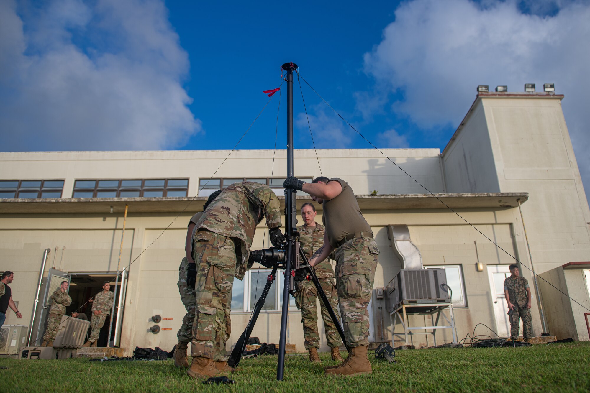 Airmen set up a radio antenna.