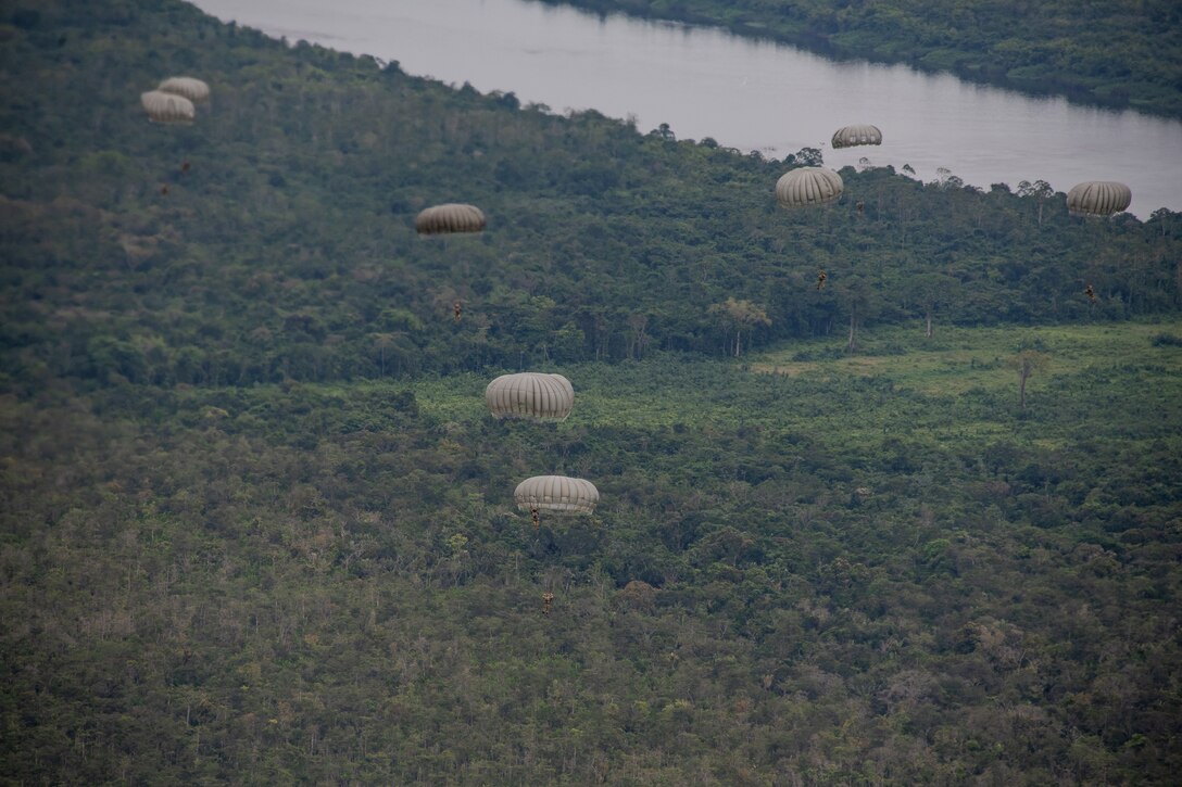 Photo: U.S. military and other national forces including France, Guyana and Mexico, participate in a static line jump during TRADEWINDS23 Exercise over Air Base London, Guyana, July 18, 2023. The different training components of the exercise are focused on increasing regional cooperation throughout the Caribbean and Caribbean Basin. (U.S. Air National Guard photo by Tech. Sgt. Brigette Waltermire)