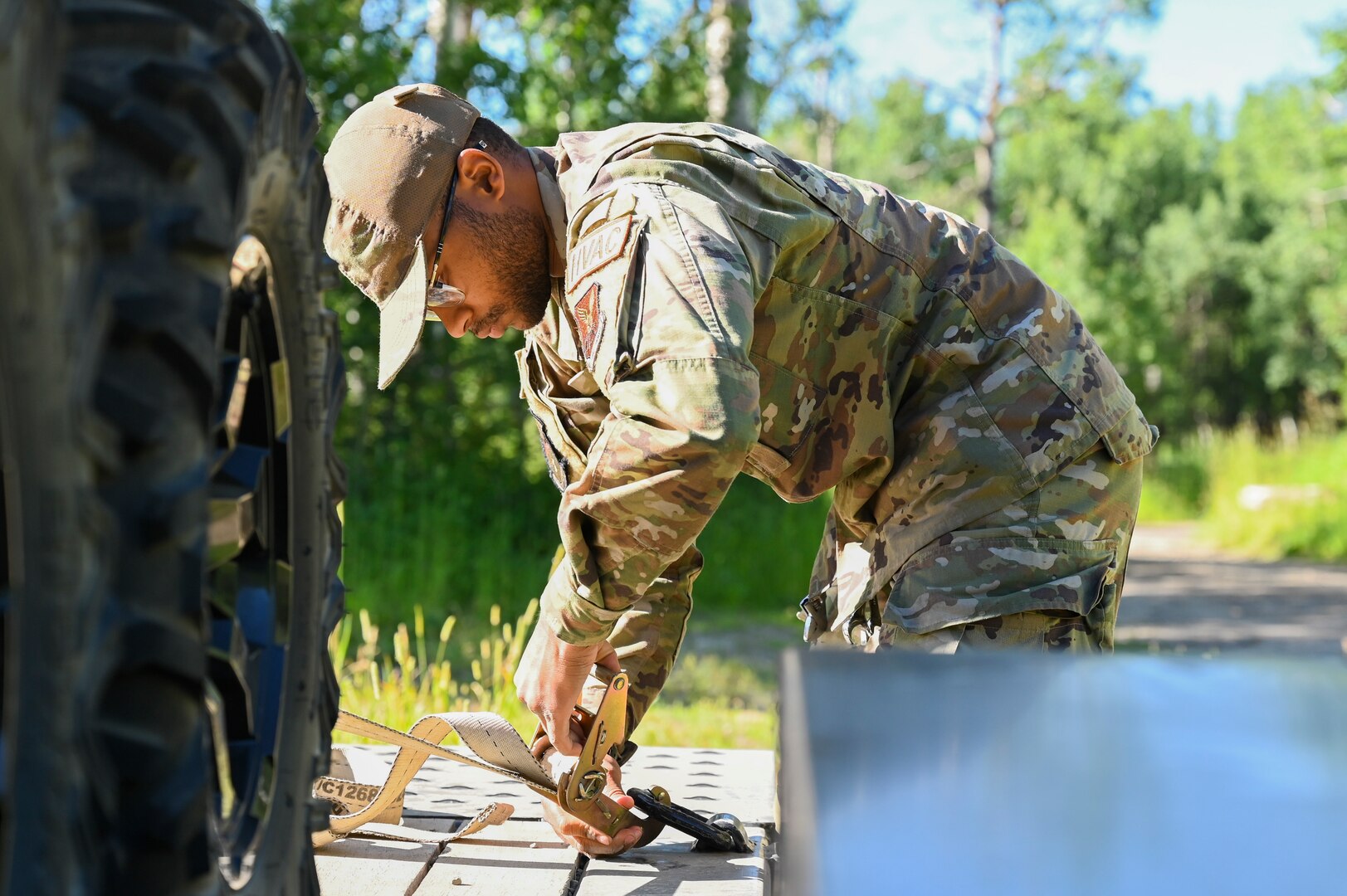 An airman untightens a trailer