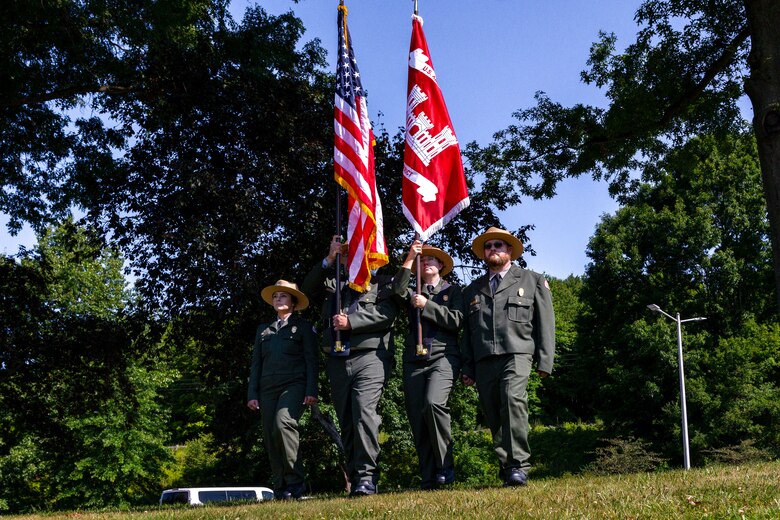 Park rangers act as the color guard during a ceremony celebrating Woodcock Creek Lake’s golden jubilee celebration in Saegertown, Pennsylvania, July 14, 2023. Community leaders and Corps of Engineers employees gathered on a summer morning to celebrate Woodcock Creek Dam’s 50th anniversary. The corps built Woodcock Creek Dam to reduce floods along the French Creek, saving communities such as Saegertown and Meadville from catastrophic flooding year after year and has prevented more than $38 million in flood damages since its construction in 1973. (U.S. Army Corps of Engineers Pittsburgh District photo by Andrew Byrne)