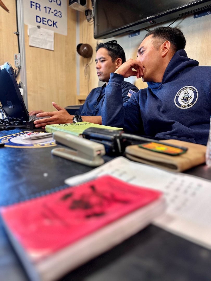 Petty Officer 1st Class Ikaika Ruiz and Petty Officer 2nd Class Ben Laguana review engineering logs aboard the USCGC Oliver Henry (WPC 1140) while underway off the Republic of Palau on March 28, 2023. The team returned to Guam on April 9, 2023, following the 30-day patrol supporting the Pacific Islands Forum Fisheries Agency's Operation 365 and Operation Rematau to stop illegal, unreported, and unregulated fishing in the Pacific. (U.S. Coast Guard photo by Chief Warrant Officer Sara Muir)