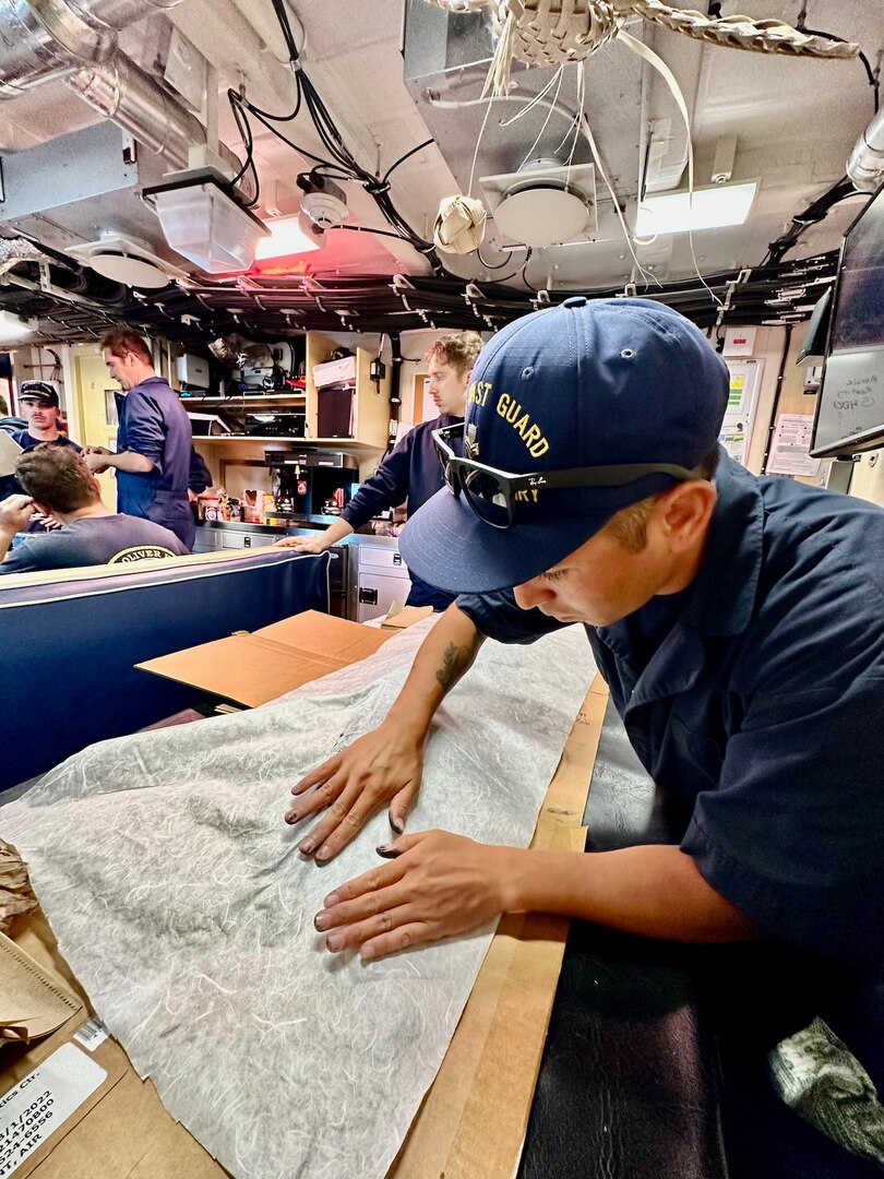 Petty Officer 1st Class Ikaika Ruiz presses an inked Wahoo with Japanese rice paper for a Gyotaku print while aboard the USCGC Oliver Henry (WPC 1140) while underway off the Republic of Palau on April 1, 2023. Originally from Hawaii, Ruiz is an engineer aboard the ship specializing as an electrician. (U.S. Coast Guard photo by Chief Warrant Officer Sara Muir)