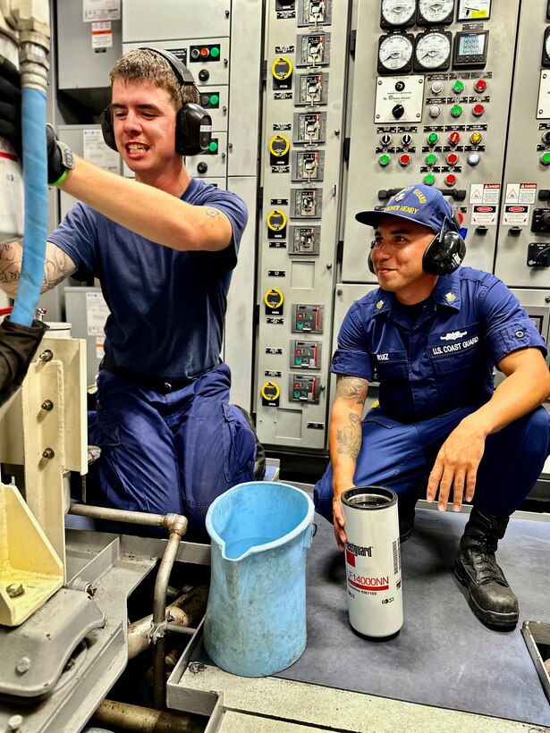 Petty Officer 3rd Class Kathan Fleming and Petty Officer 1st Class Ikaika Ruiz conduct a routine oil change on a generator aboard the USCGC Oliver Henry (WPC 1140) off Palau on April 4, 2023. The crew returned to Guam on April 9, 2023, following the 30-day patrol supporting the Pacific Islands Forum Fisheries Agency's Operation 365 and Operation Rematau to stop illegal, unreported, and unregulated fishing in the Pacific. (U.S. Coast Guard photo by Chief Warrant Officer Sara Muir)