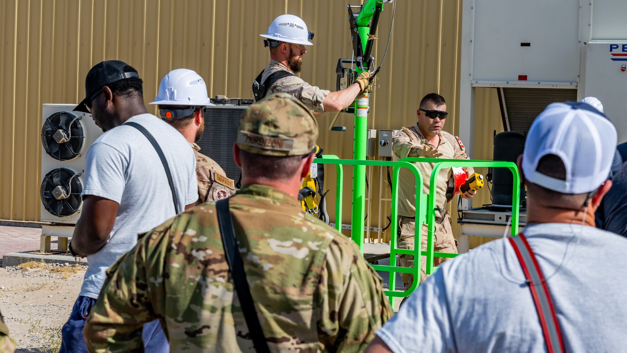 Canadian armed forces members teach a group of U.S. Air Force Airmen about the equipment they use to perform confined-space operations at Ali Al Salem Air Base, Kuwait, July 25, 2023. This confined-space training allowed for the U.S. and our Canadian partners to share their knowledge and expertise, thus reducing the risks associated with confined-space operations for all. (U.S. Air Force photo by Staff Sgt. Kevin Long)