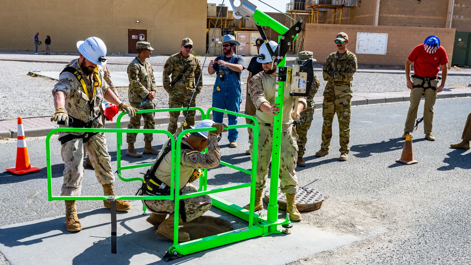 Canadian armed forces members demonstrate how their confined-space pulley system works during confined-space training at Ali Al Salem Air Base, Kuwait, July 25, 2023. This confined-space training allowed for the U.S. and our Canadian partners to share their knowledge and expertise, thus reducing the risks associated with confined-space operations for all. (U.S. Air Force photo by Staff Sgt. Kevin Long)