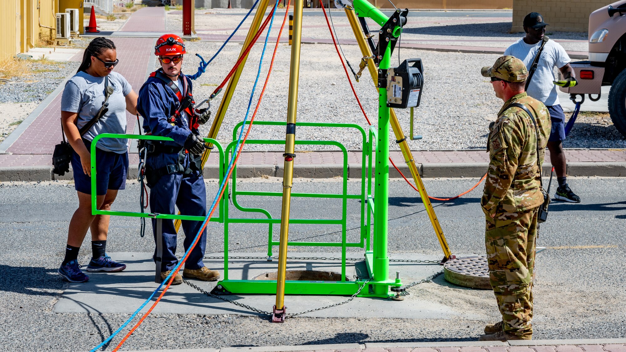 U.S. Air Force fire protection Airmen from the 386th Expeditionary Civil Engineer Squadron prepare to demonstrate how they would perform a confined-space rescue at Ali Al Salem Air Base, Kuwait, July 25, 2023. This confined-space training allowed for the U.S. and our Canadian partners to share their knowledge and expertise, thus reducing the risks associated with confined-space operations for all. (U.S. Air Force photo by Staff Sgt. Kevin Long)