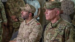 commanding general and colonel listen to briefing