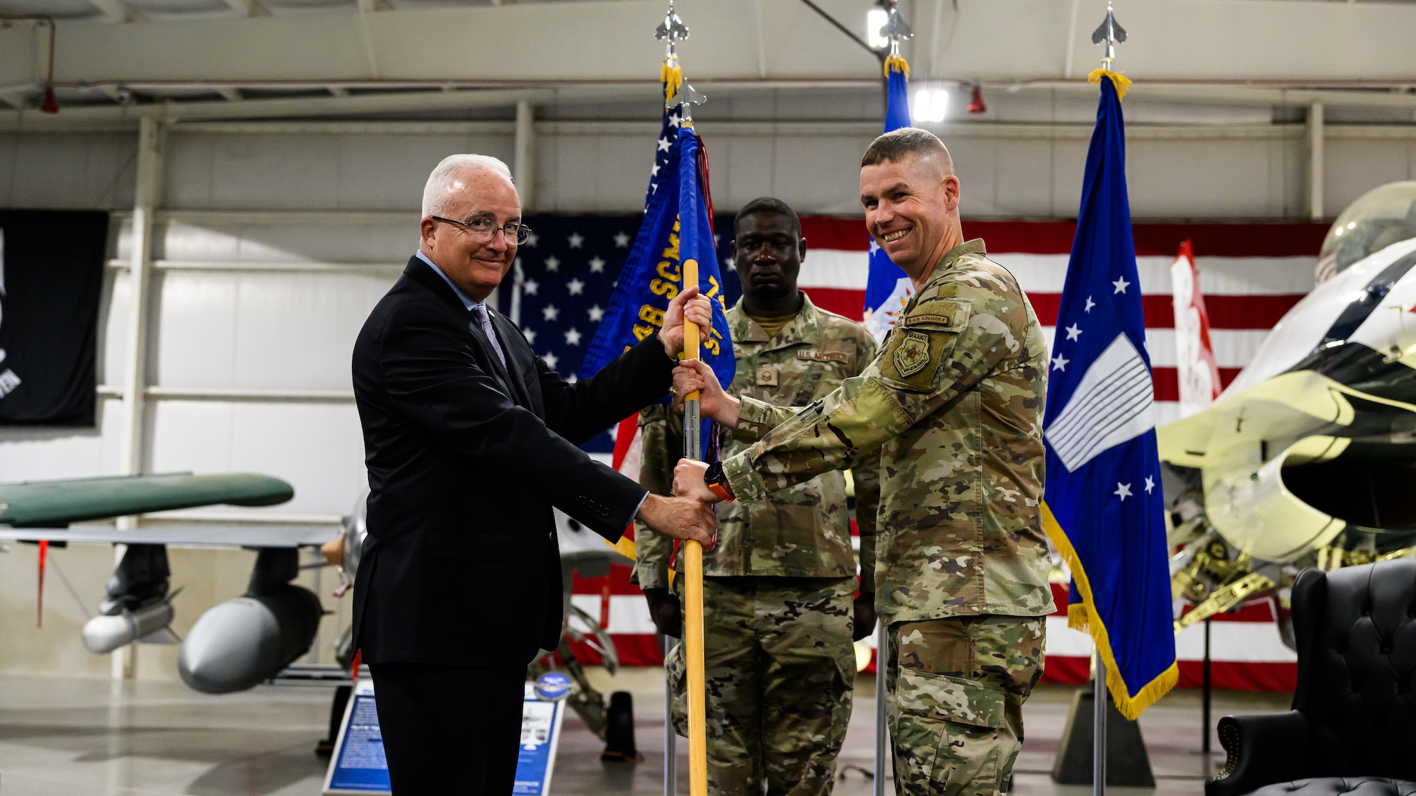 Right, Col. Gregory Boschert, incoming 748th Supply Chain Management Group commander, receives the guidon from Stephen Gray, 448th Supply Chain Management Wing director, during a change of command ceremony at Hill Air Force Base, Utah, July 26, 2023. The 748th SCMG sustains weapon systems worldwide by providing supply chain management life cycle support to include developing enterprise demand and supply plans, developing and implementing sourcing strategies, executing the supply plan, and executing cognizant engineering authority to meet customer requirements for aircraft structural and avionics systems, landing gear, secondary power systems, and space & command, control, communications and intelligence commodities. (U.S. Air Force photo by R. Nial Bradshaw)