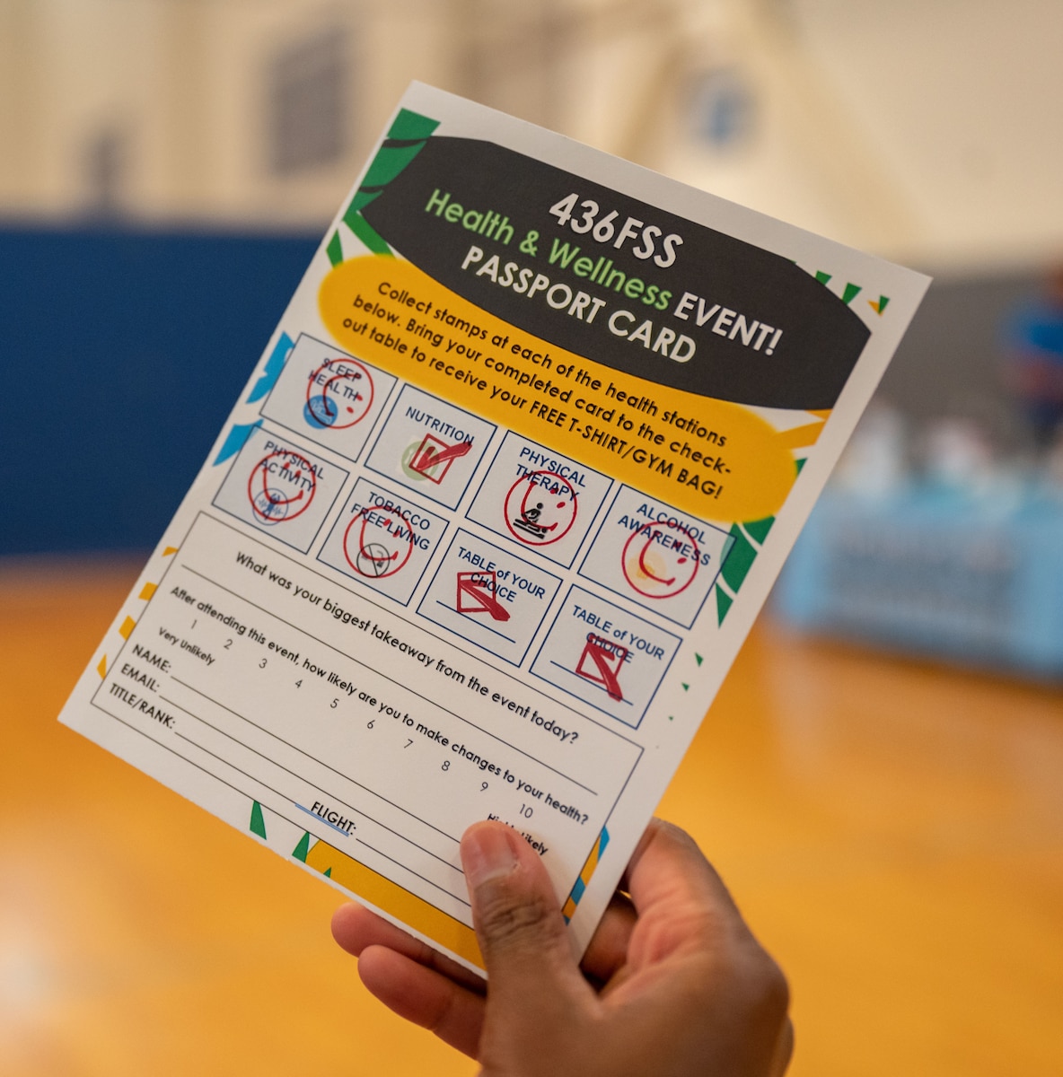 A Team Dover Airman holds a stamped event passport card during the 436th Force Support Squadron Health and Wellness Fair at Dover Air Force Base, Delaware, July 26, 2023. Each participant received an event passport card used to collect stamps from various booths for an opportunity to receive a free T-shirt. (U.S. Air Force photo by Senior Airman Cydney Lee)