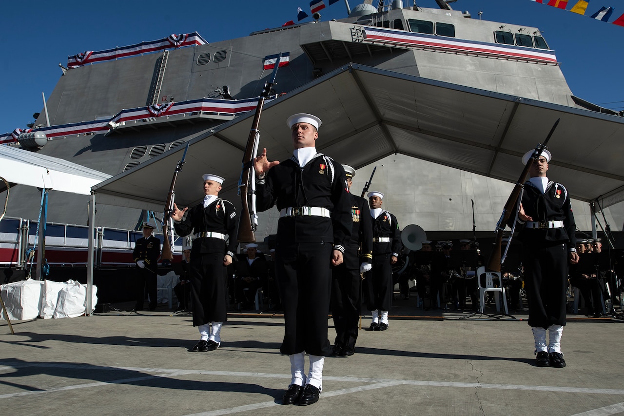 Ceremonial guard sailors perform near a ship.