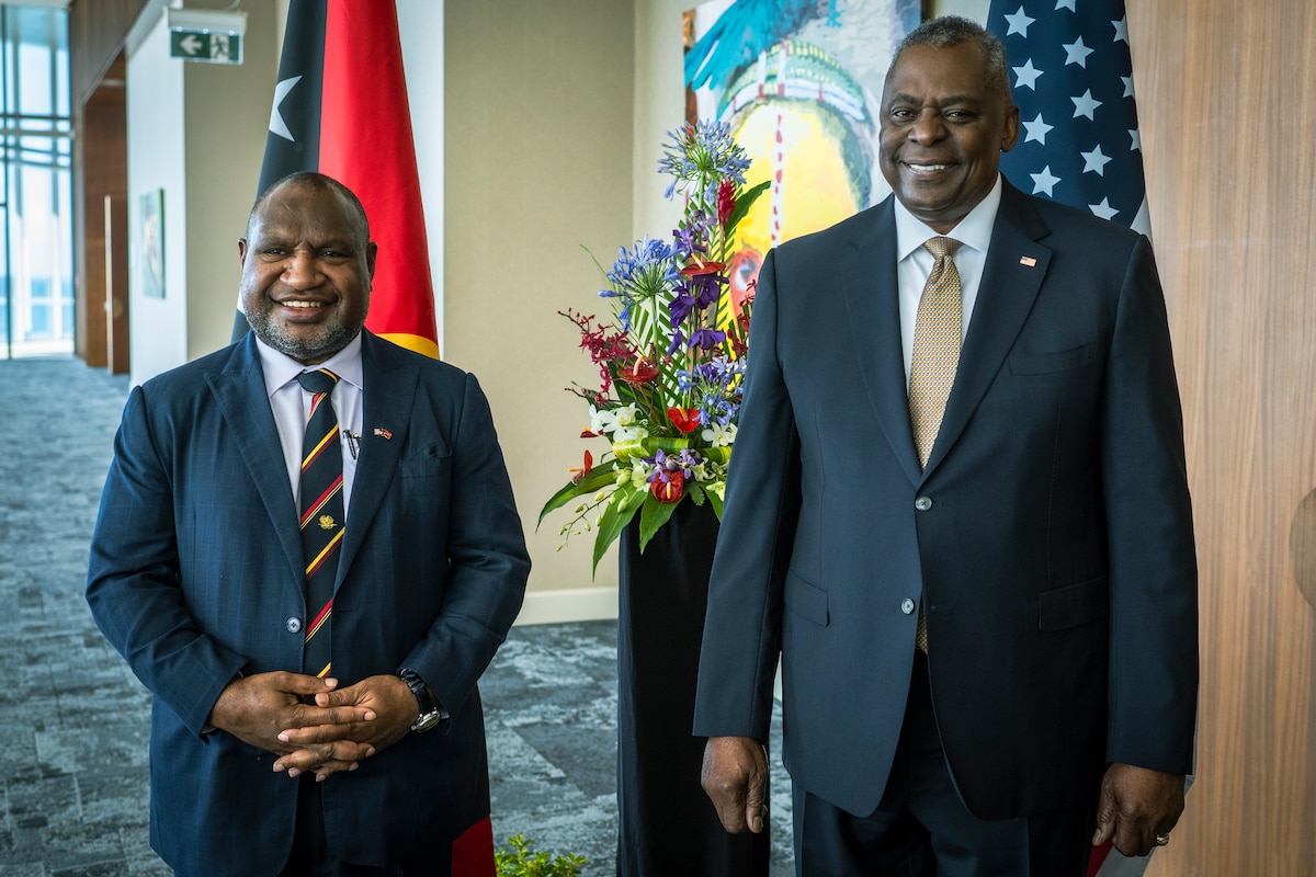 Two men pose for a photo.