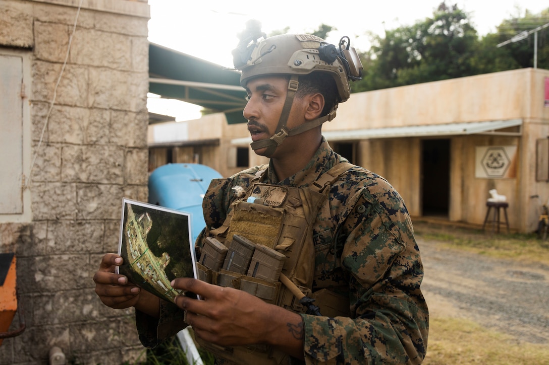 U.S. Marine Corps Cpl. Nathanial Beyene, a student in the Advanced Infantry Marine Course with Advanced Infantry Training Battalion, School of Infantry-West, Hawaii Detachment, briefs Marines before a patrol during urban operations training, Marine Corps Training Area Bellows, July 11, 2023. The training was conducted as part of the Advanced Infantry Marine Course. AIMC is designed to enhance and test Marines’ skills with a focus on reinforcing proper patrols and operational procedures. (U.S. Marine Corps photo by Cpl. Chandler Stacy)