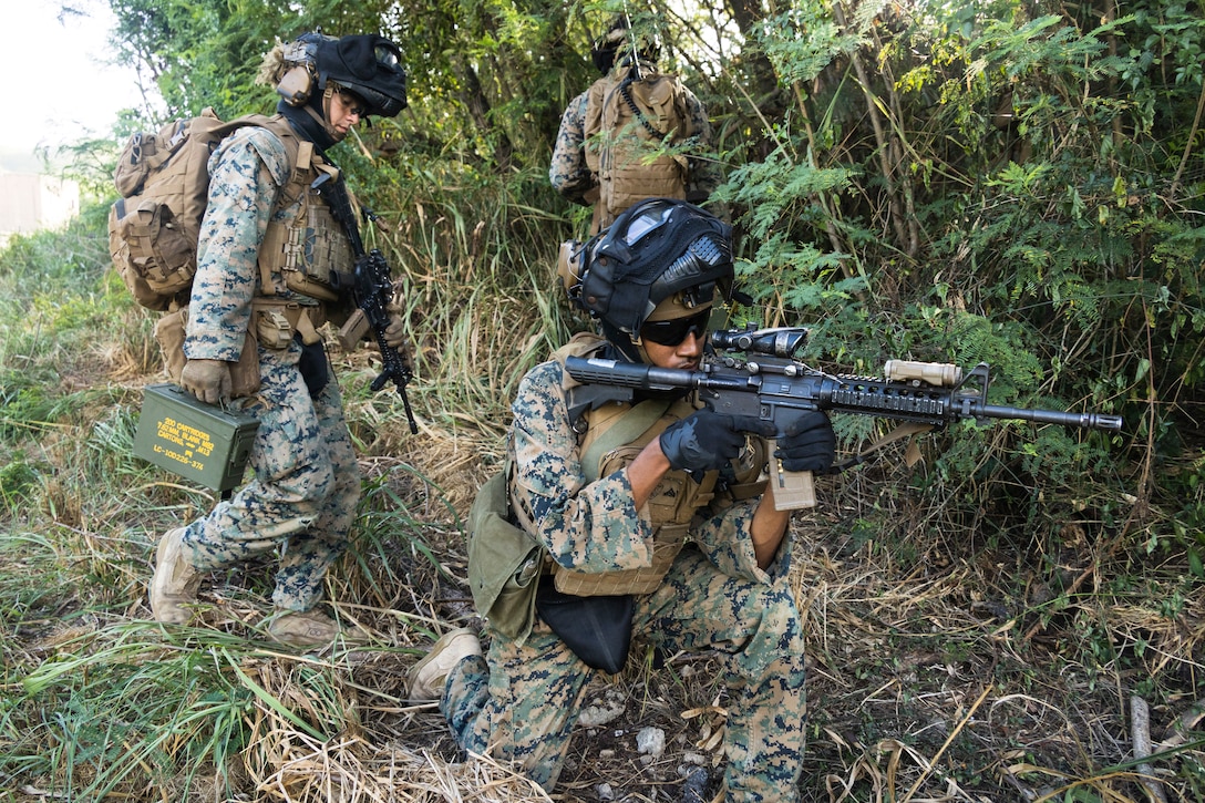 U.S. Marines with Advanced Infantry Training Battalion, School of Infantry-West, Hawaii Detachment, travers through rough terrain during urban operations training, Marine Corps Training Area Bellows, July 11, 2023. The training was conducted as part of the Advanced Infantry Marine Course. AIMC is designed to enhance and test Marines’ skills with a focus on reinforcing proper patrols and operational procedures. (U.S. Marine Corps photo by Cpl. Chandler Stacy)