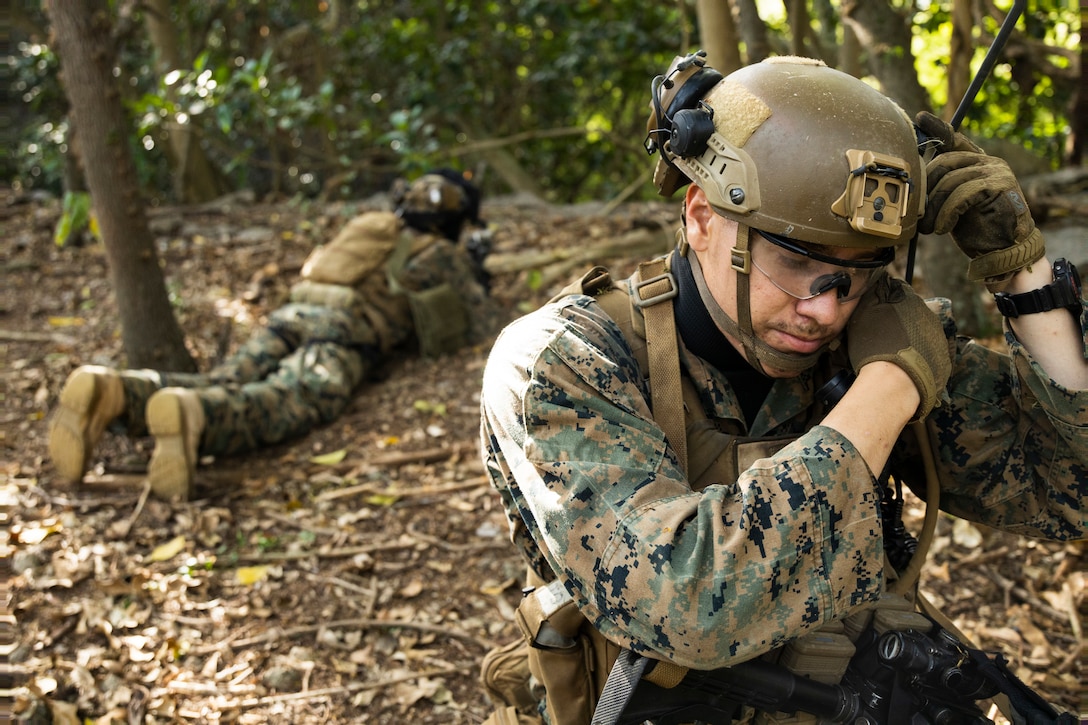 U.S. Marine Corps Cpl. Patrick Romero, a student in the Advanced Infantry Marine Course with Advanced Infantry Training Battalion, School of Infantry-West, Hawaii Detachment, establishes communications during urban operations training, Marine Corps Training Area Bellows, July 11, 2023. The training was conducted as part of the Advanced Infantry Marine Course. AIMC is designed to enhance and test Marines’ skills with a focus on reinforcing proper patrols and operational procedures. (U.S. Marine Corps photo by Cpl. Chandler Stacy)