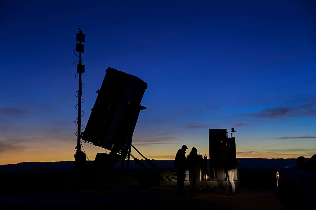As dusk descends, Marines and civilians from the Program Manager for Ground-Based Air Defense assemble around Program Executive Officer Land System’s cutting-edge Medium Range Intercept Capability system. Serving as the Corps’ first medium range missile capability since the HAWK system, this state-of-the-art capability proved its mettle by successfully hitting targets at the White Sands Missile Range, New Mexico, on December 16, 2021.