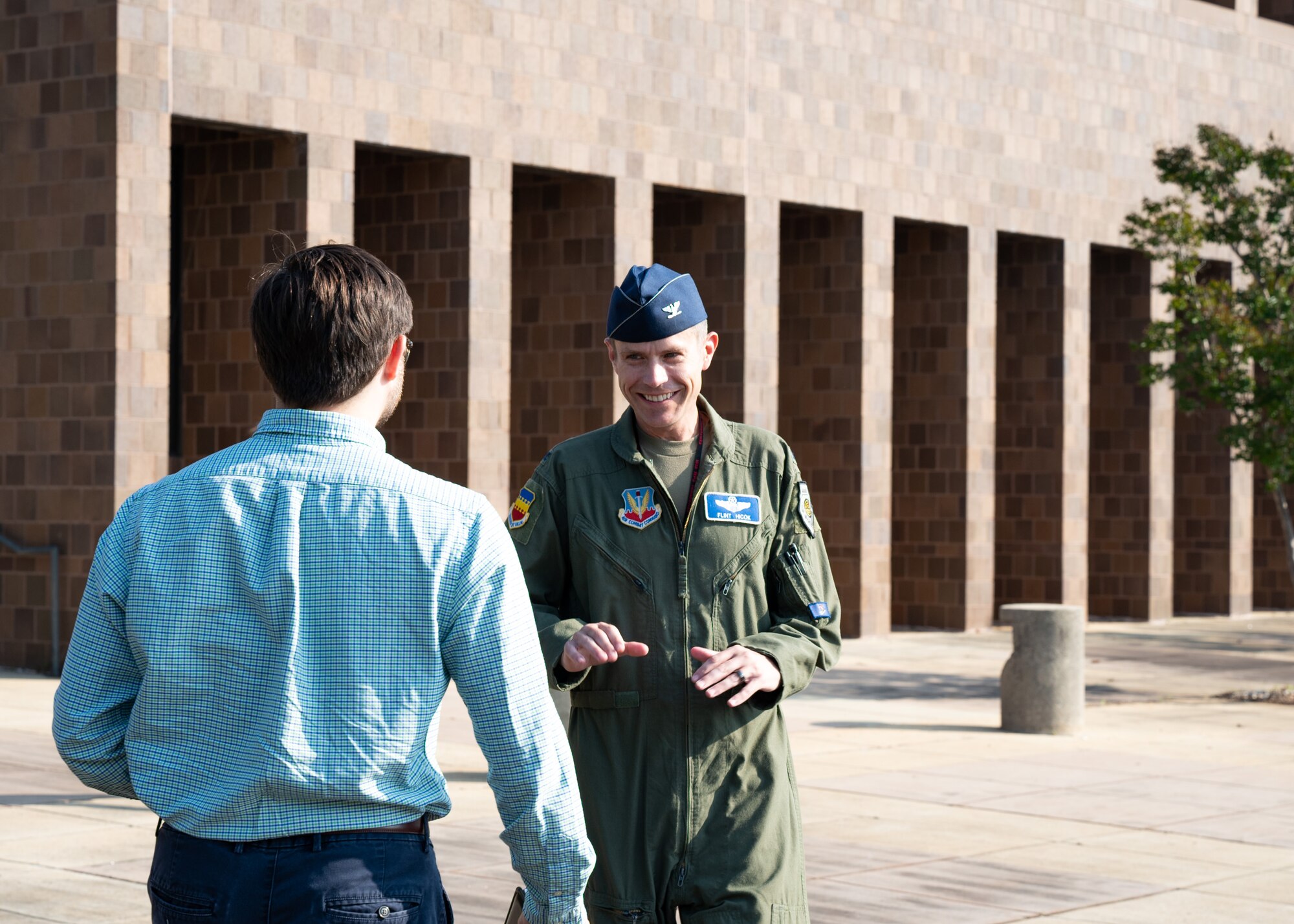 Two individuals greet each other outside of the 20th Fighter Wing Headquarters building at Shaw Air Force Base, S.C.
