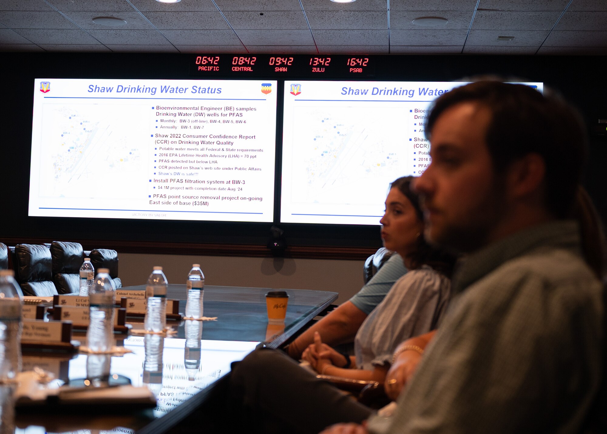 A man is presented a brief in a darkened conference room at Shaw Air Force Base, S.C.