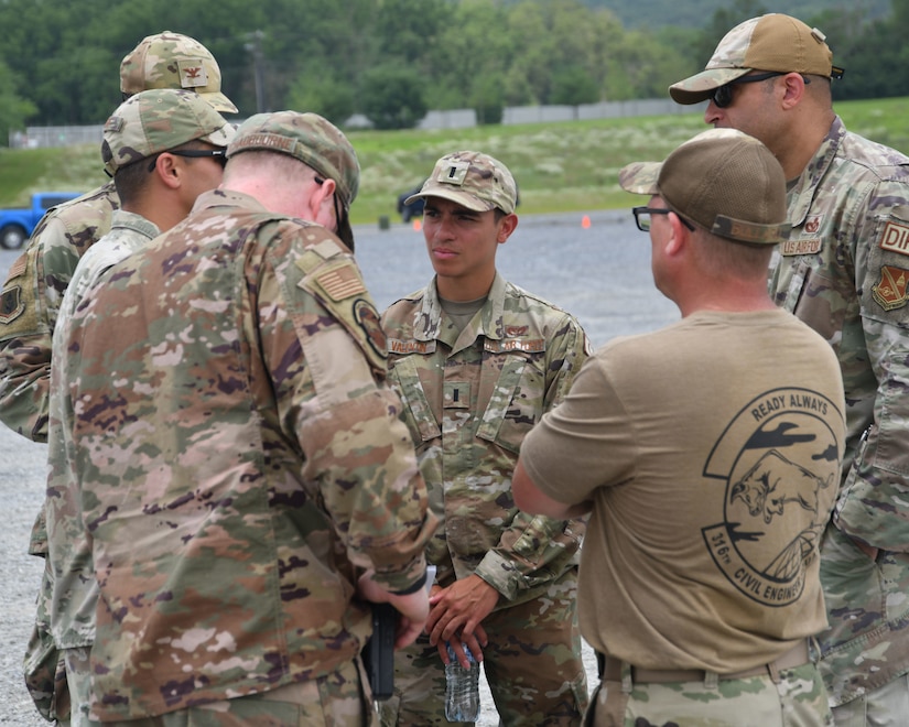 Men in military uniforms stand in a group.