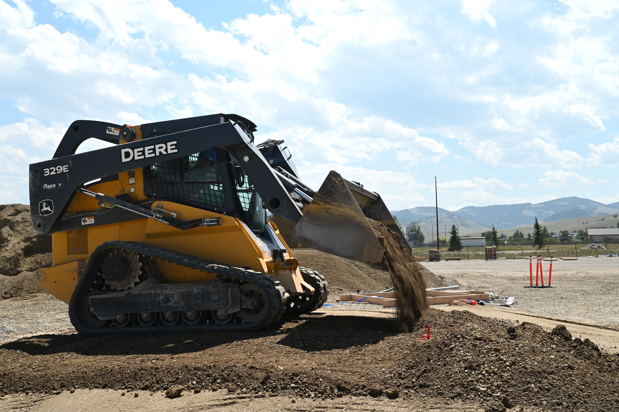 Staff Sgt. Eric Wise, 131st Civil Engineer Squadron, operates a compact track loader to prepare a building site at Fort William Henry Harrison, Montana, July 25, 2023. Civil Engineering Airmen gain valuable deployment and job skills on projects like this while saving taxpayer dollars in construction costs. (U.S. Air National Guard photo by Airman 1st Class Phoenix Lietch)