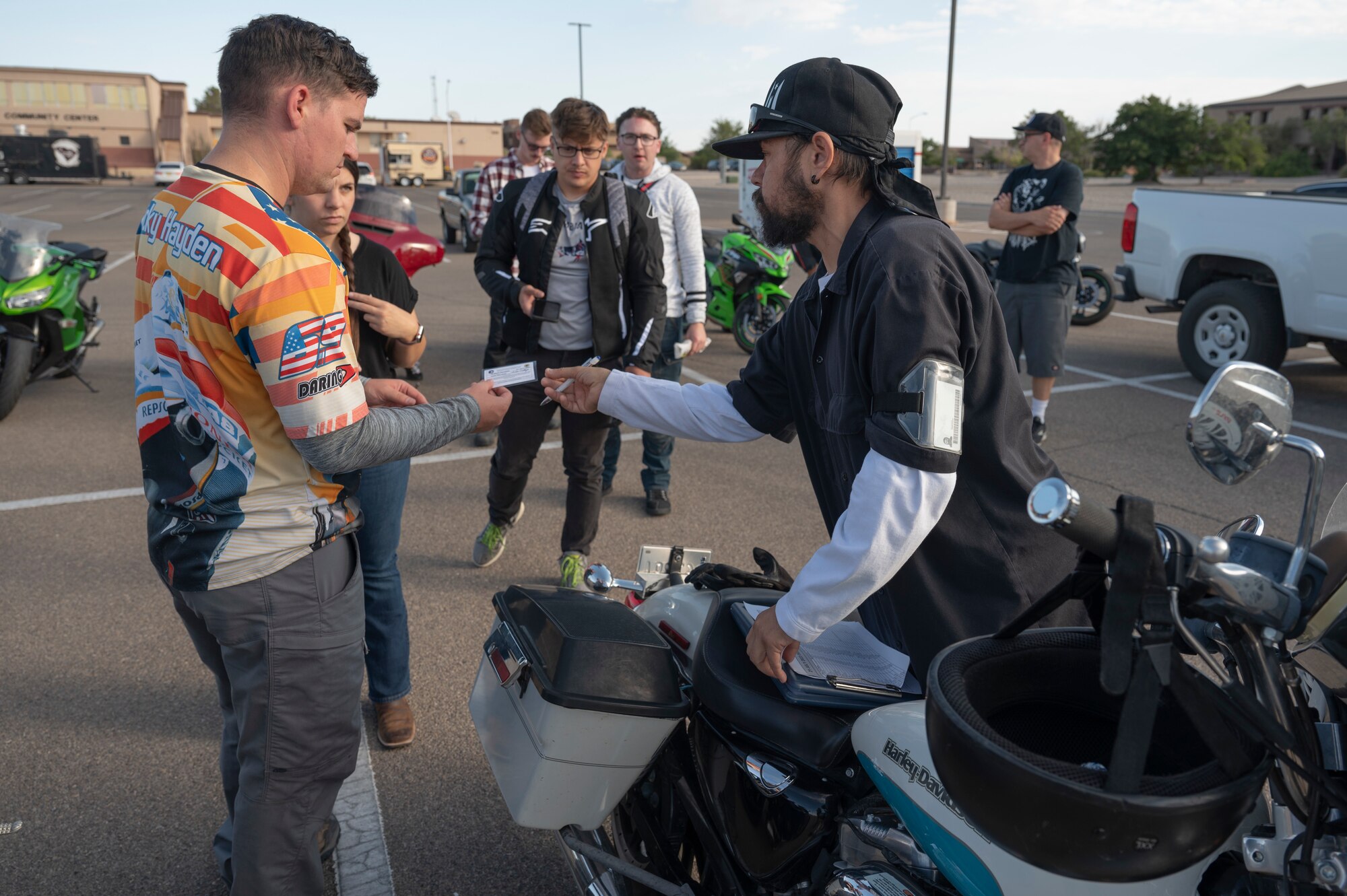 Holloman members receive a safety brief from Ivan Vallejo, 49th Wing Safety motorcycle program and occupational safety manager, prior to a mentorship ride at Holloman Air Force Base, New Mexico, July 21, 2023. Mentorship rides allow commanders to coordinate counseling and inspections of riders to ensure their motorcycles are safe to operate and they possess serviceable safety equipment. (U.S. Air Force photo by Airman 1st Class Michelle Ferrari)