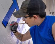 Matt Grimes, painter, Shop 71, Painters, works inside Capt. Patrick M. Rapicault Hall, at Puget Sound Naval Shipyard & Intermediate Maintenance Facility, in Bremerton, Washington. (U.S. Navy photo by Wendy Hallmark)
