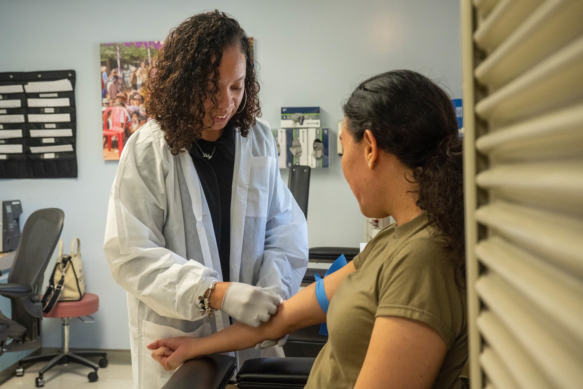 Melinda Lara, 15th Medical Group Diagnostics and Therapeutics flight phlebotomist performs a blood draw on Senior Airman Merissa Ocegueda, 15th MDG Diagnostics and Therapeutics flight laboratory technician at Joint Base Pearl Harbor-Hickam, Hawaii, July 20, 2023. The laboratory recently earned a perfect score on the civilian accreditation from the College of American Pathologists. (U.S. Air Force photo by Senior Airman Makensie Cooper)