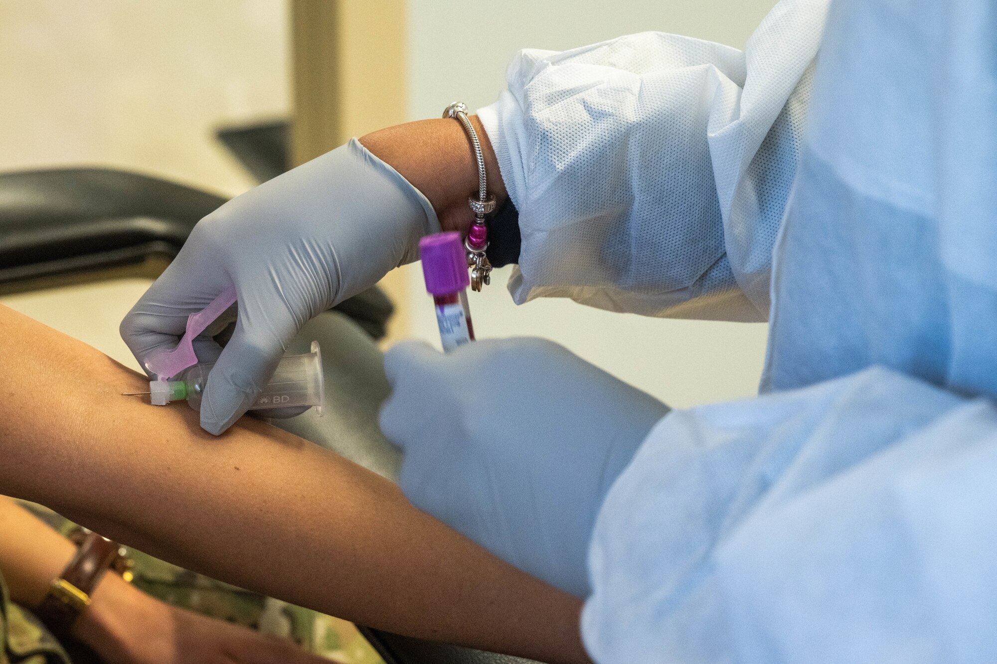 Melinda Lara, 15th Medical Group Diagnostics and Therapeutics flight phlebotomist performs a blood draw on Senior Airman Merissa Ocegueda, 15th MDG Diagnostics and Therapeutics flight laboratory technician at Joint Base Pearl Harbor-Hickam, Hawaii, July 20, 2023. The laboratory recently earned a perfect score on the civilian accreditation from the College of American Pathologists. (U.S. Air Force photo by Senior Airman Makensie Cooper)
