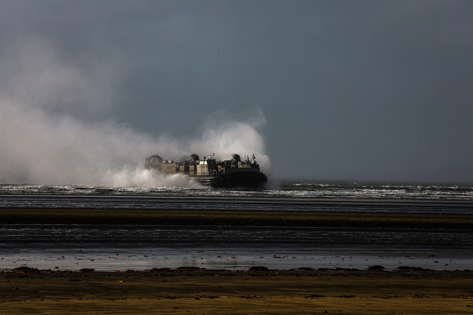 A U.S. Navy Landing Craft Air Cushion lands ashore as a part of Talisman Sabre 23 in Midge Point, Australia, July 25, 2023. Amphibious operations provide a Combined-Joint Force Commander the capability to rapidly project power ashore in support of crisis response at the desired time and location. (U.S. Army Photo by Staff Sgt. Jessica Elbouab)