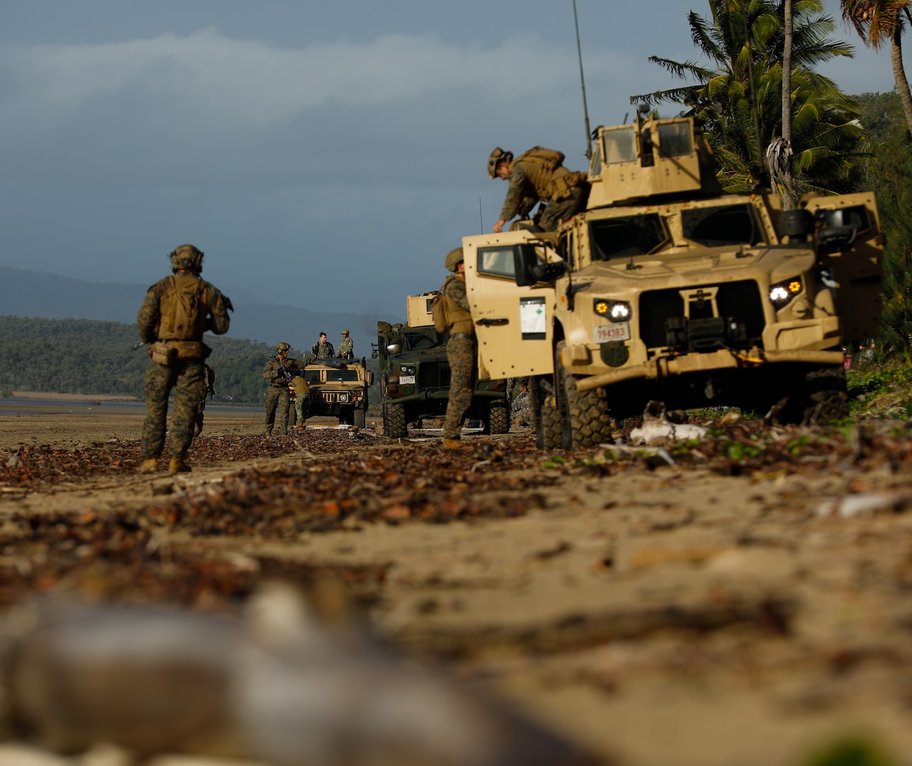 Marines from the 31st Marine Expeditionary Unit offload Joint Light Tactical Vehicles as part of Talisman Sabre 23 at Midge Point, Australia, July 25, 2023. As the stand-in force operating within the first island chain of the Indo-Pacific, the Marine Corps trains to fight in a distributed maritime environment where sensing, targeting, and long-range precision fire capabilities are established to support naval operations at sea. (U.S. Army Photo by Staff Sgt. Jessica Elbouab)