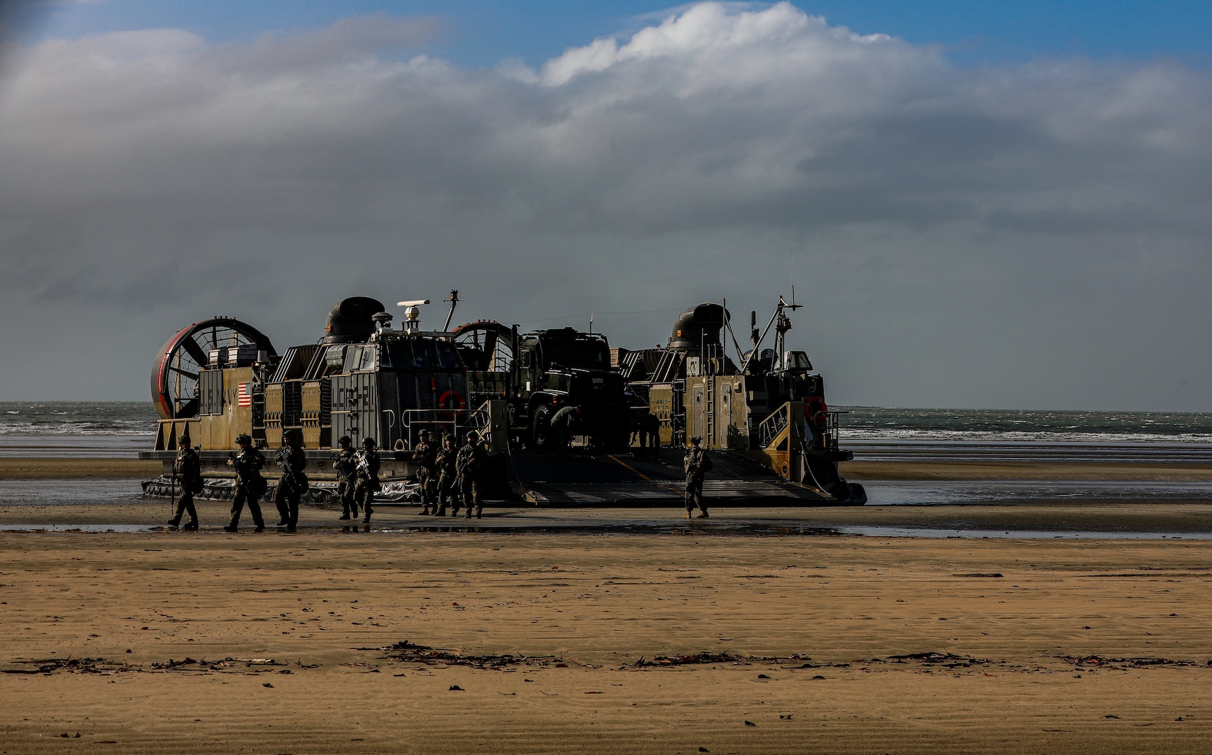 German Army soldiers offload after landing onshore via Landing Craft Air Cushion as part of Talisman Sabre 23 in Midge Point, Australia, July 25, 2023. Amphibious operations provide a combined-joint force commander the capability to rapidly project power ashore to support crisis response at the desired time and location. (U.S. Army Photo by Staff Sgt. Jessica Elbouab)