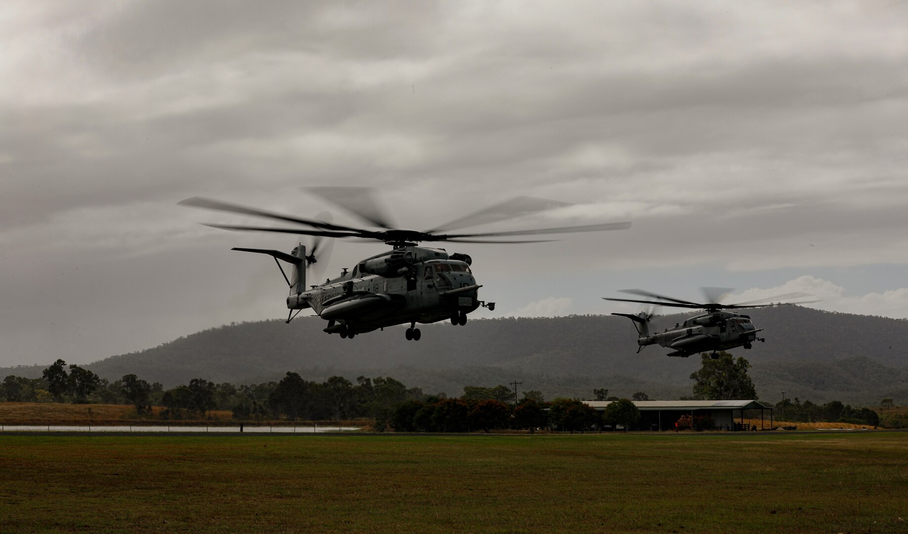 Two U.S. Marine Corps CH-53D Sea Stallions, land as a part of Talisman Sabre 23 in Midge Point, Australia, July 25, 2023. TS23 allows 1st and 3d Marine Divisions and other elements of I and III Marine Expeditionary Forces to train closely with allies and joint partners to enhance our collective capabilities, readiness, and effectiveness in preparation for any crisis or contingency in the future. (U.S. Army Photo by Staff Sgt. Jessica Elbouab)