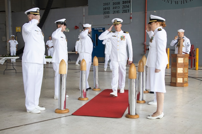 U.S. Navy Cmdr. Mark D. Kerber, oncoming commanding officer, Fleet Logistics Support Squadron (VR) 51, Fleet Logistics Support Wing, makes his entrance during the arrival of the official party of a change of command ceremony at Marine Corps Air Station Kaneohe Bay, Marine Corps Base Hawaii, July 14, 2023. Cmdr. Heath Leggett relinquished command to Kerber. (U.S. Marine Corps photo by Sgt. Julian Elliott-Drouin)