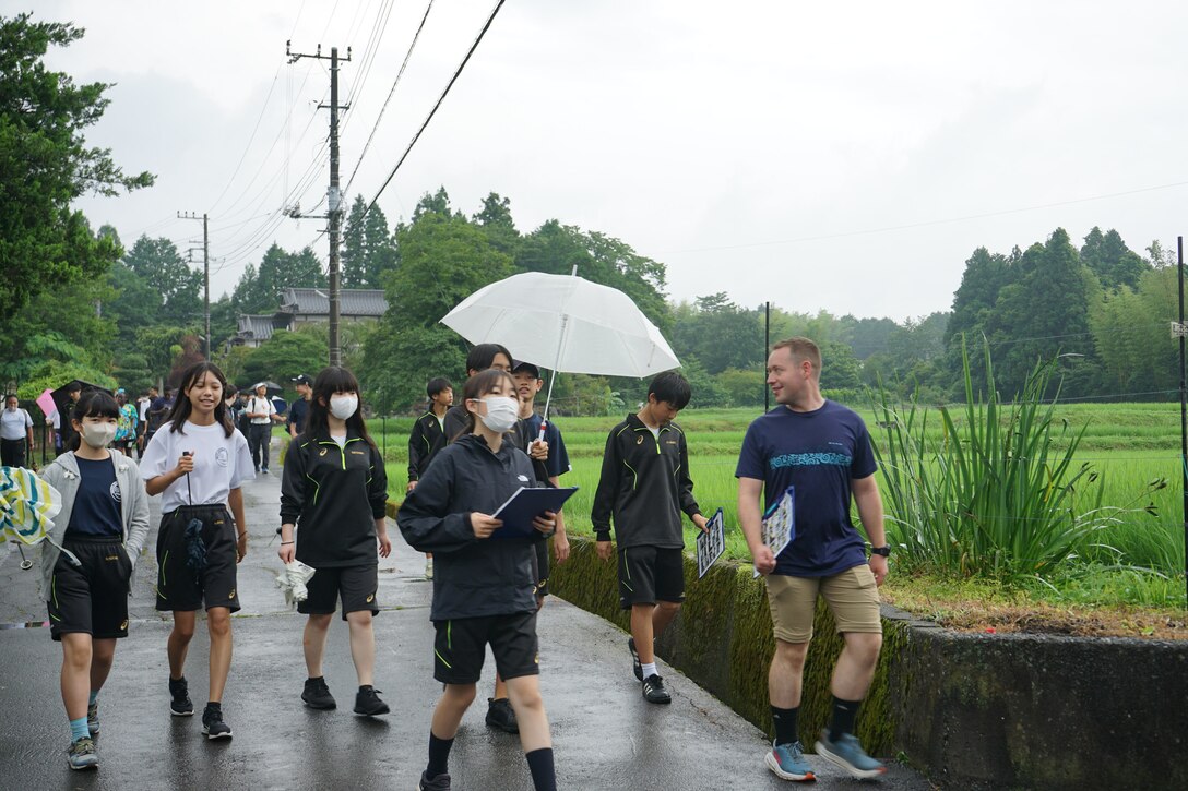 A Marine from Combined Arms Training Center, Camp Fuji, Japan walks with students during their visit to the National Chuo Youth Friendship Center in Gotemba, Japan. (Courtesy photos by Pvt. Victoria Sanchez)