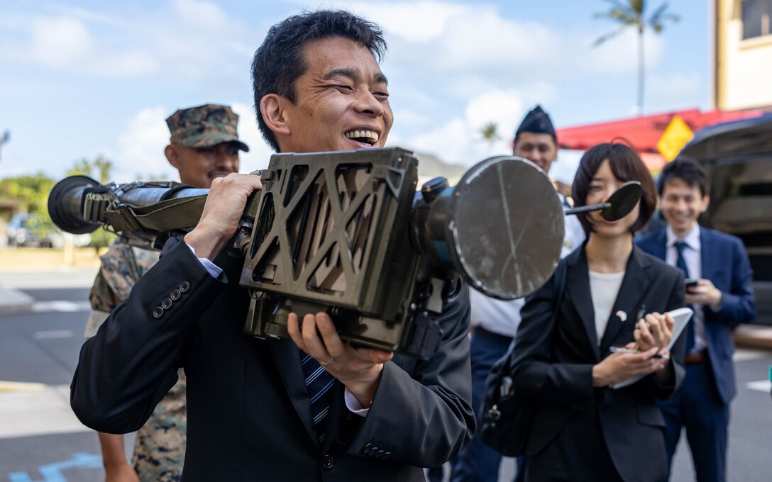 Mr. Ino Toshiro, State Minister of Defense, Japan Defense Ministry, holds a Stinger Missile launch tube during a static display on Marine Corps Base Hawaii, Hawaii on July 11, 2023. MARFORPAC, MCBH, and the 3rd Marine Littoral Regiment hosted State MOD Ino to discuss U.S. Marine Corps transformational improvements to its capabilities, and how these improvements will optimize our force posture in the Indo-Pacific, including in Japan. These improvements will provide more versatile, resilient, and mobile capabilities for the defense of Japan, in accordance with the January 2023 Joint Statement of the U.S. Japan Security Consultative Committee (2+2). (U.S. Marine Corps photo by Cpl. Haley Fourmet Gustavsen)