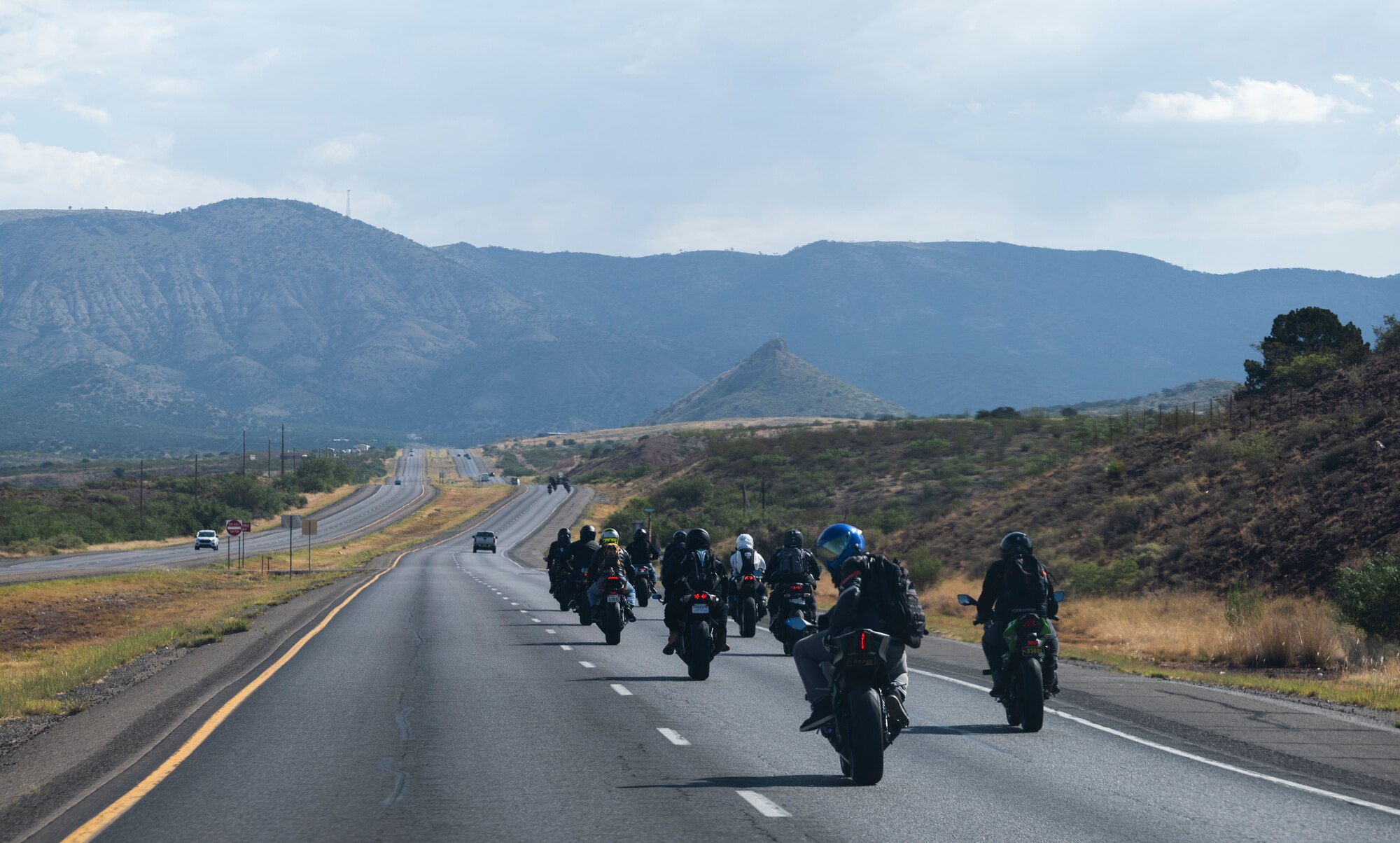Airmen from Holloman travel through the countryside of New Mexico on their motorcycles during a group mentorship ride near Holloman Air Force Base, New Mexico, July 21, 2023. Mentorship rides allow commanders to coordinate counseling and inspections of riders to ensure they’re motorcycles are safe to operate and they possess serviceable safety equipment. (U.S. Air Force photo by Airman 1st Class Michelle Ferrari)