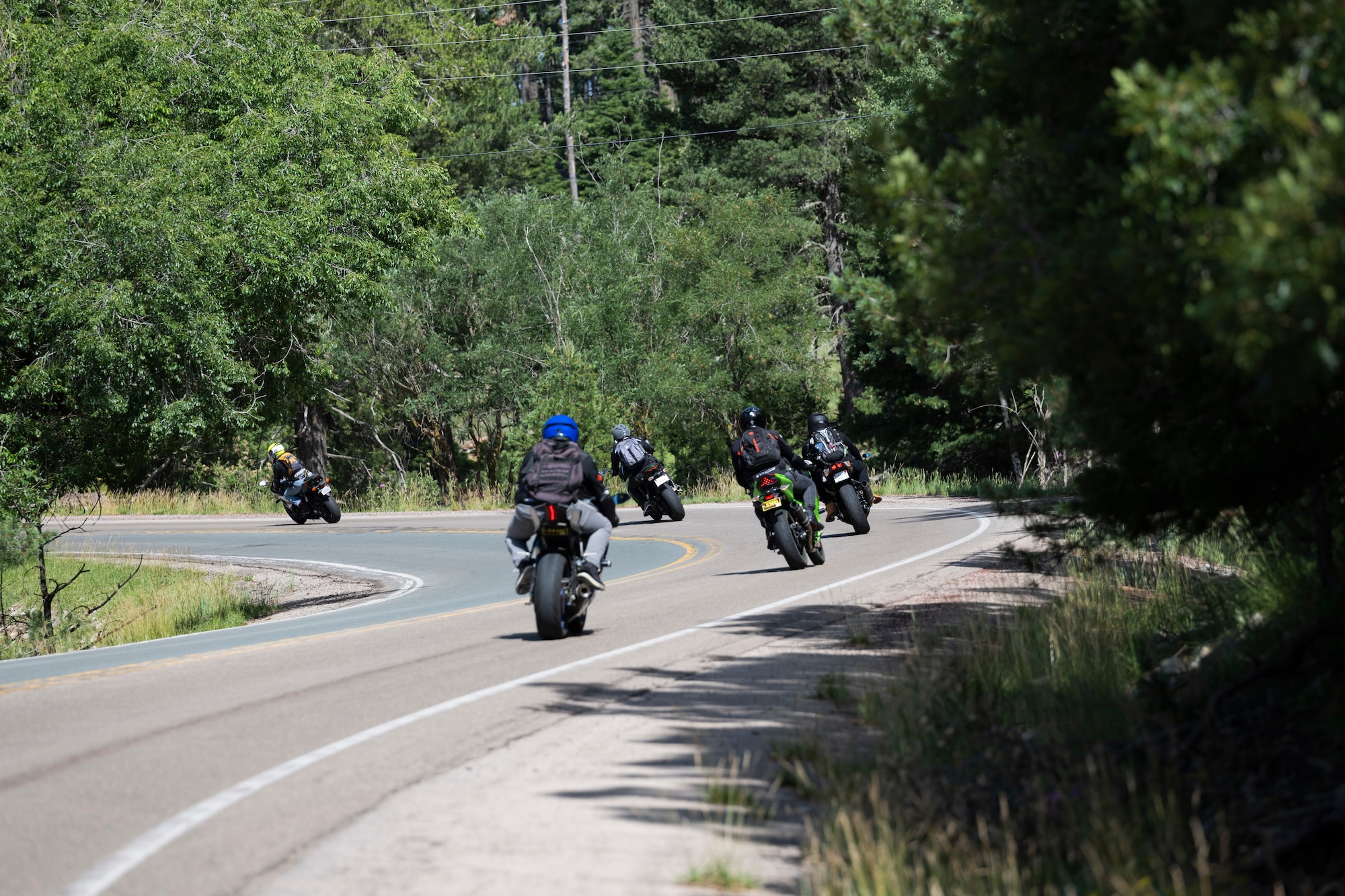 Airmen from Holloman travel through Ruidoso on their motorcycles during a group mentorship ride near Holloman Air Force Base, New Mexico, July 21, 2023. Mentorship rides allow commanders to coordinate counseling and inspections of riders to ensure their motorcycles are safe to operate and they possess serviceable safety equipment. (U.S. Air Force photo by Airman 1st Class Michelle Ferrari)