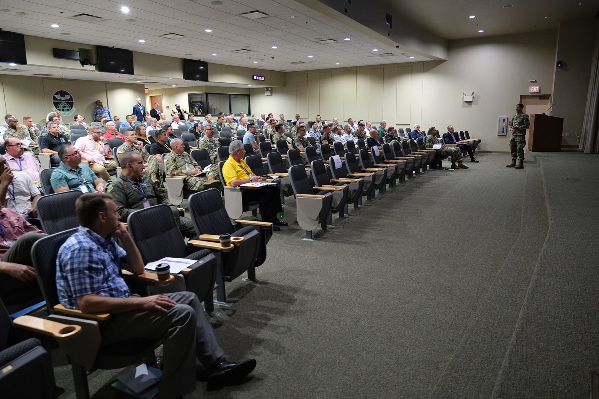 photo of large classroom filled with civilians and military members sitting in chairs