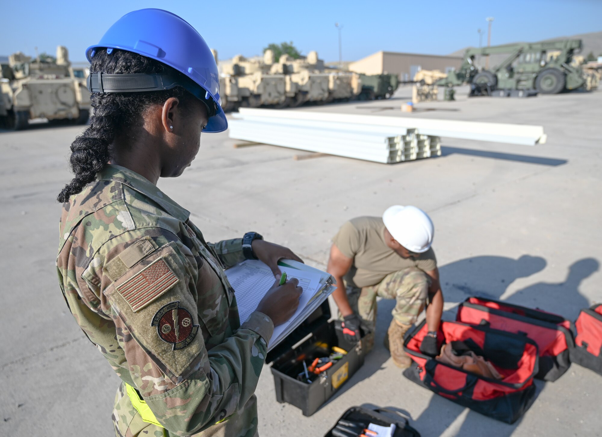 Senior Airman Kerris Eady, 131st Civil Engineer Squadron operations management, checks equipment inventory for a M1 Abrams storage facility at Fort William Henry Harrison, Montana, July 25, 2023. 131st Airmen are building the facility in conjunction with other Air National Guard units from across the country. (U.S. Air National Guard photo by Airman 1st Class Phoenix Lietch)