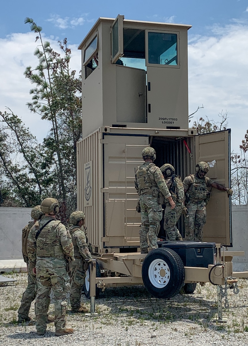 Airmen in and around an observation tower