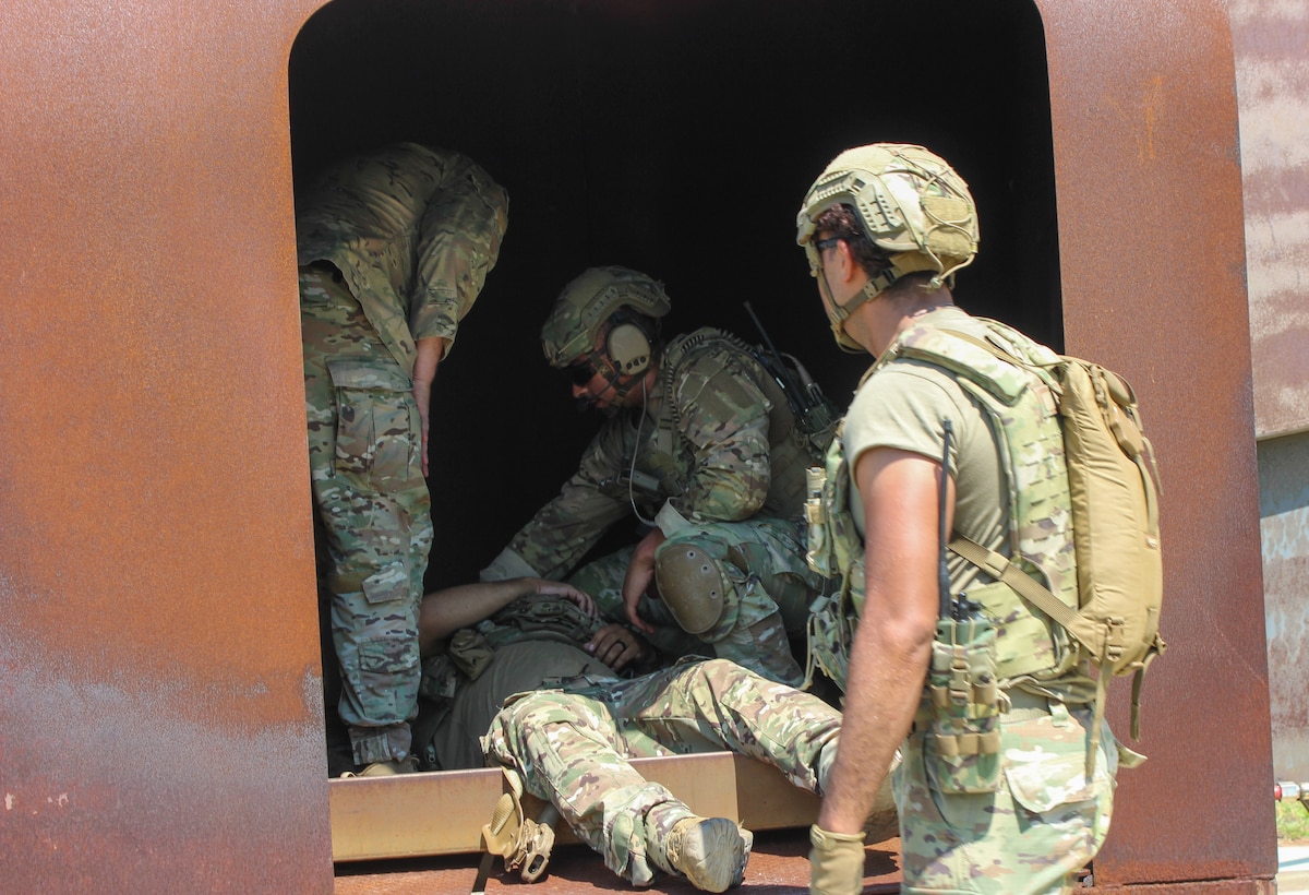 Airmen load a "casualty" into a simulated helicopter