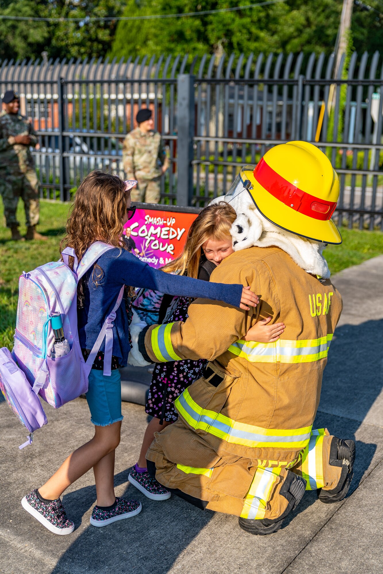 Sparky, Keesler Fire Department, welcomes Ara and Harper Resio, daughters of Christopher Resio, before their first day of school at Keesler Air Force Base, Mississippi, July 27, 2023.