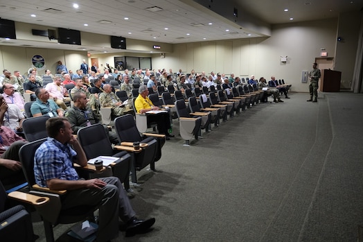  photo of large classroom filled with civilians and military members sitting in chairs